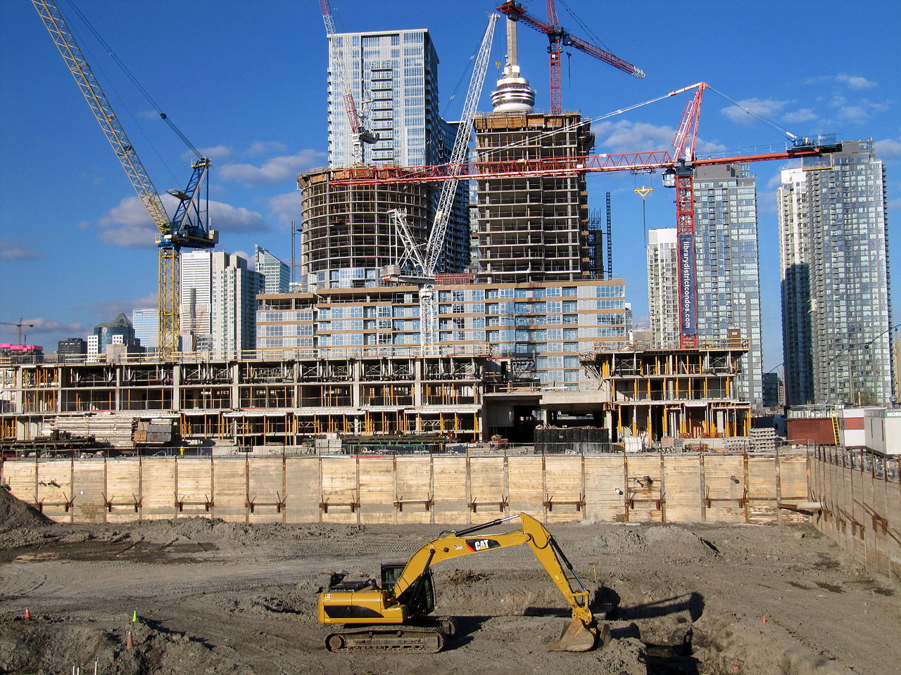 Photo showing construction in Toronto with CN Tower in the background. Blog by Wins Lai Toronto Real Estate Agent