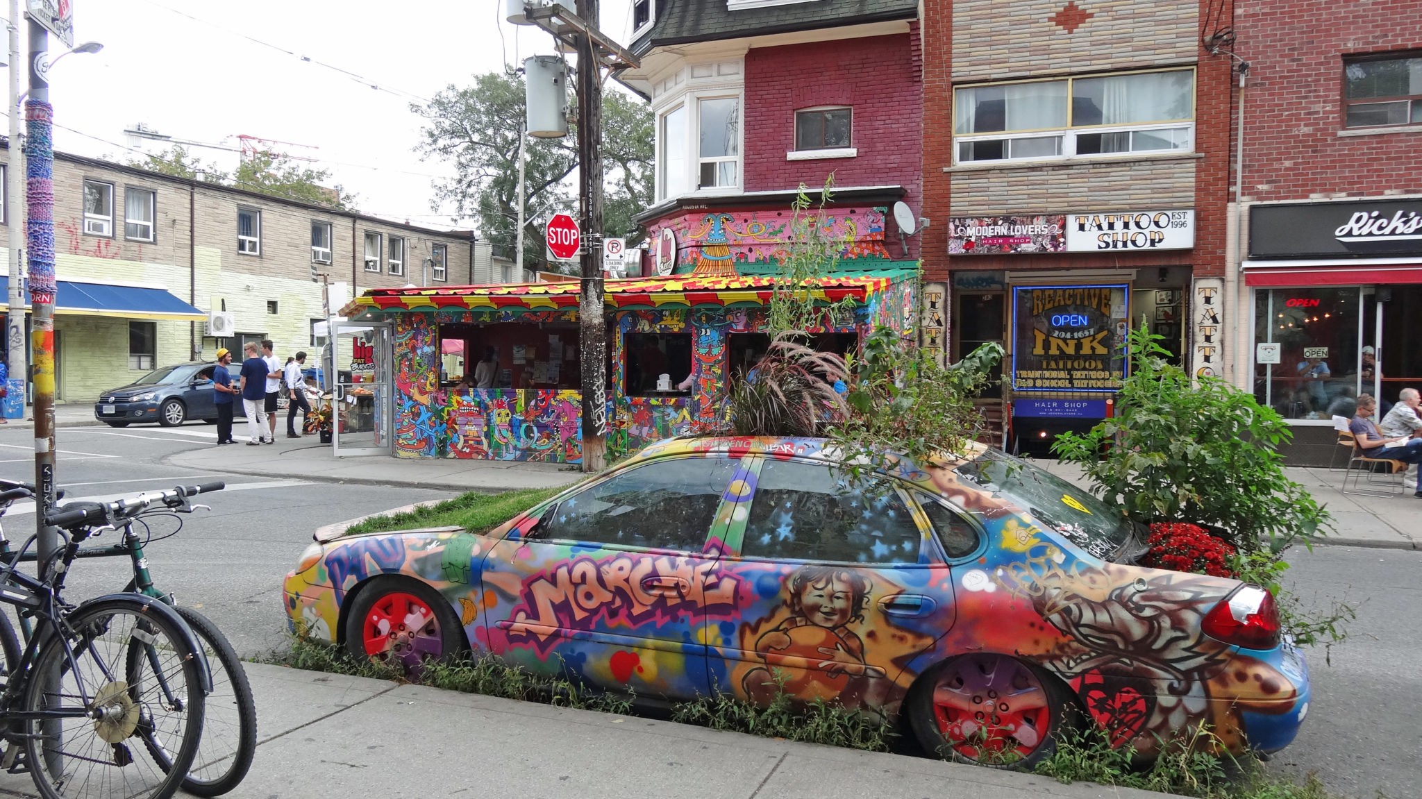 Photo of Kensington Market, streets and colorful car. Toronto Real Estate Agent.