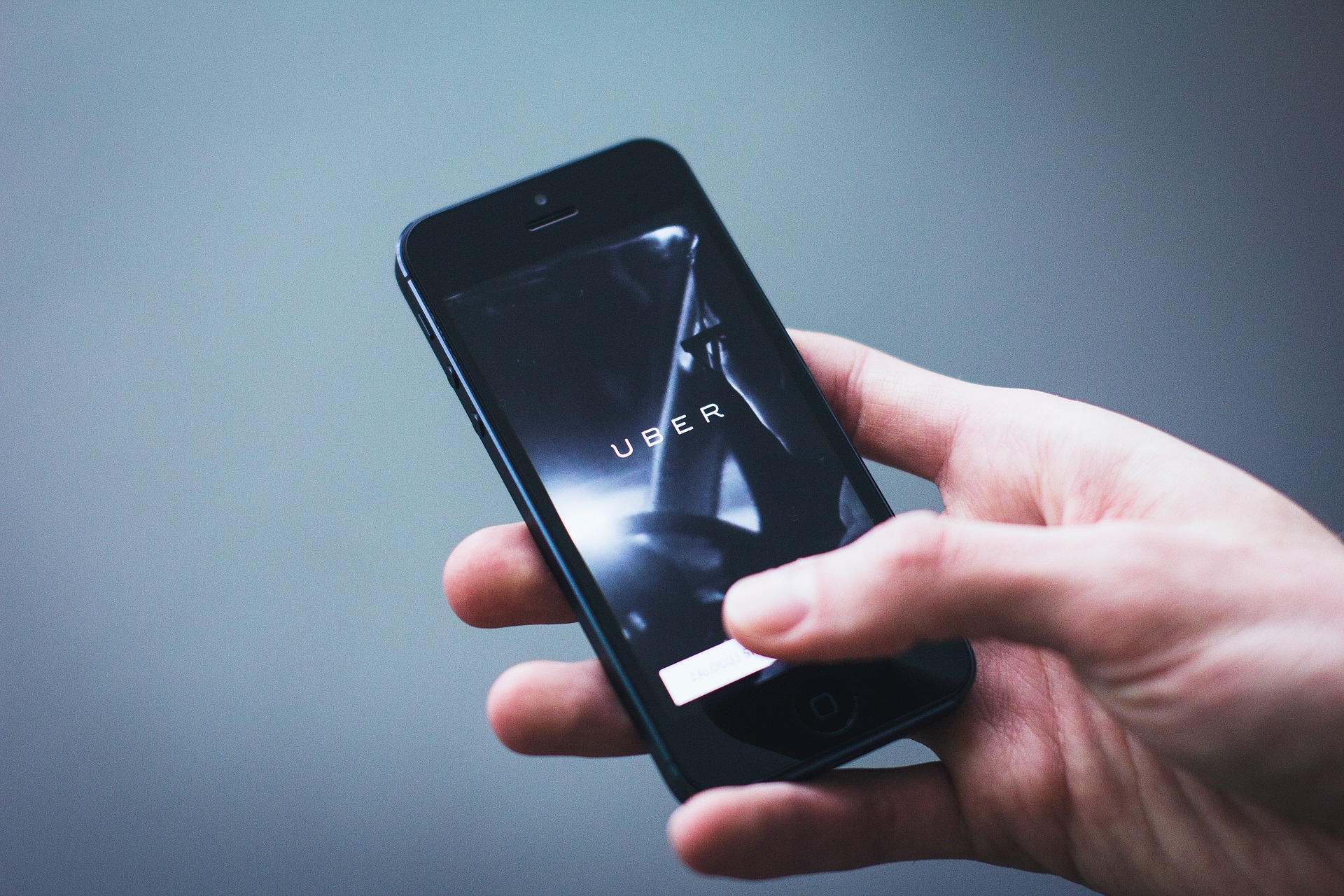 Hand holding cellphone with Uber app looking so nice. Yet so much is due to, while, since it happened. It seems like that, maybe, probably, almost never.