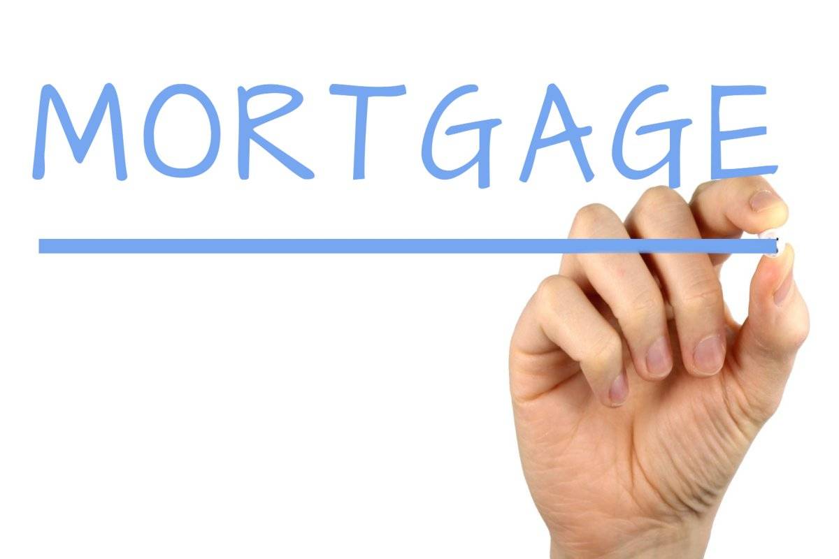 Image of word mortgage and a hand under it.