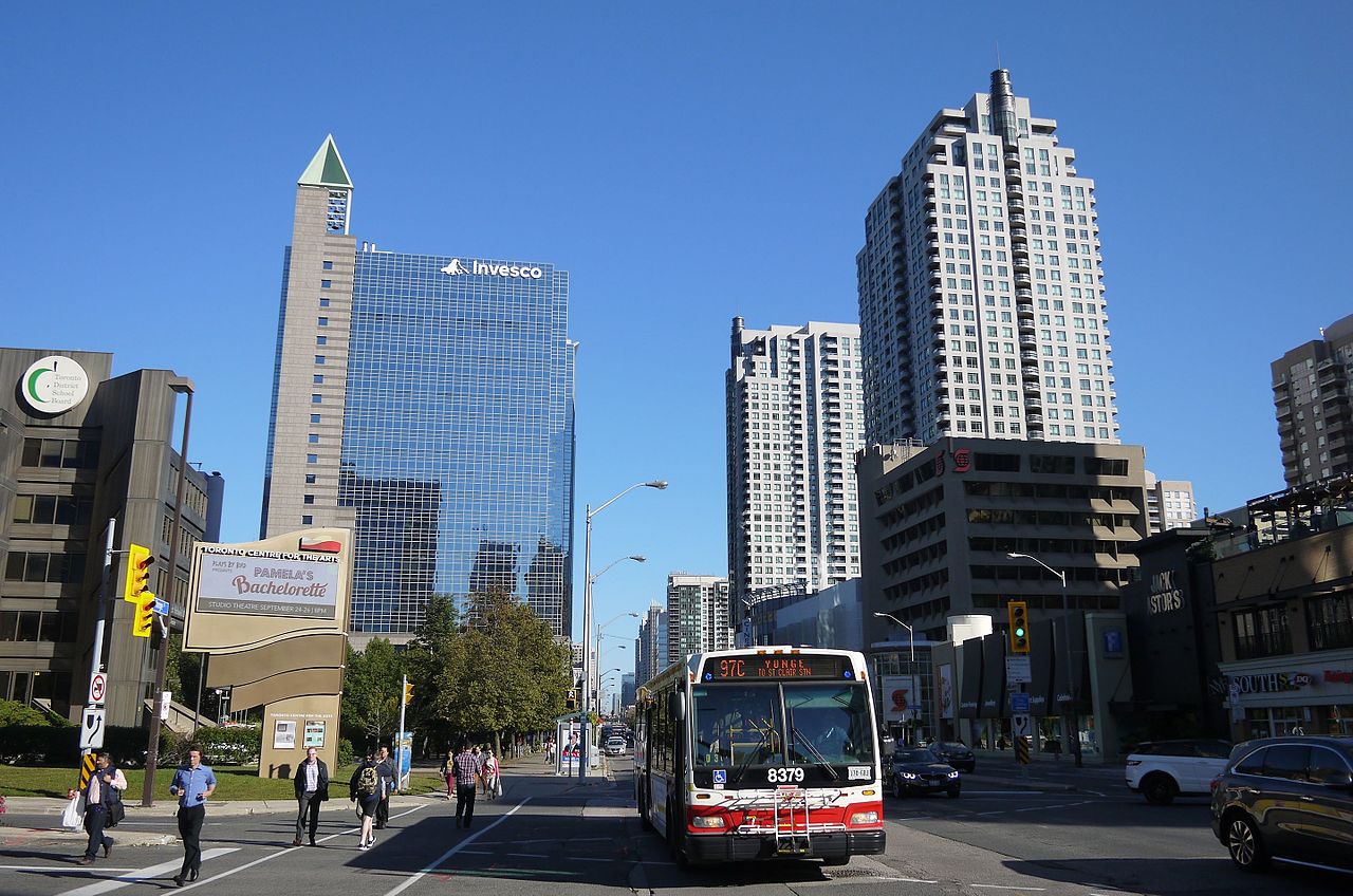 Photo of Downtown North York and bus and people and buildings and streets.