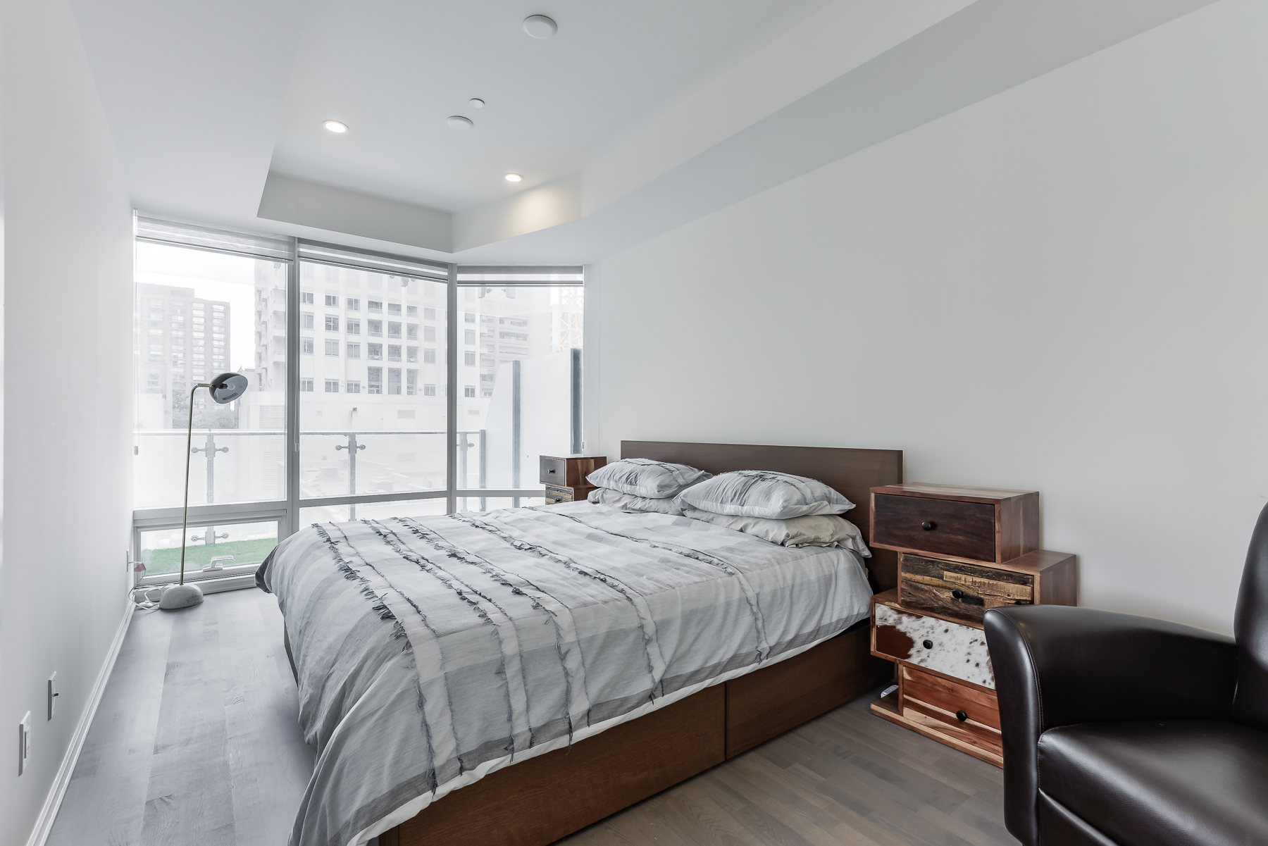 Master bedroom and bed - 1 Bloor St E Unit 310 Toronto.