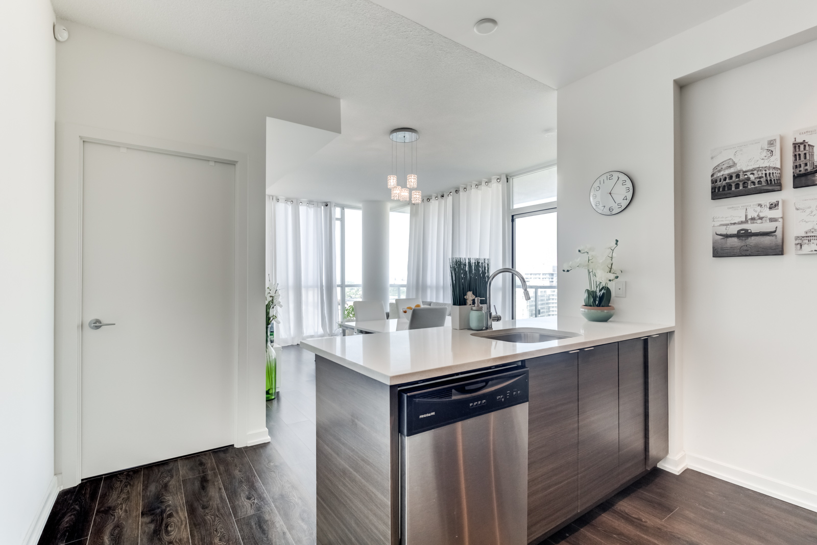 Kitchen breakfast bar with built-in dishwasher at 62 Forest Manor Rd Unit 1803, Toronto.