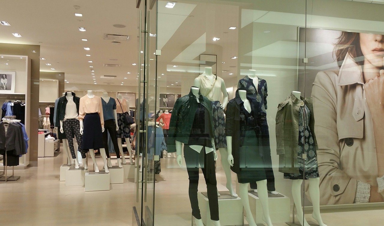 Store display with mannequins on King West with female fashions.