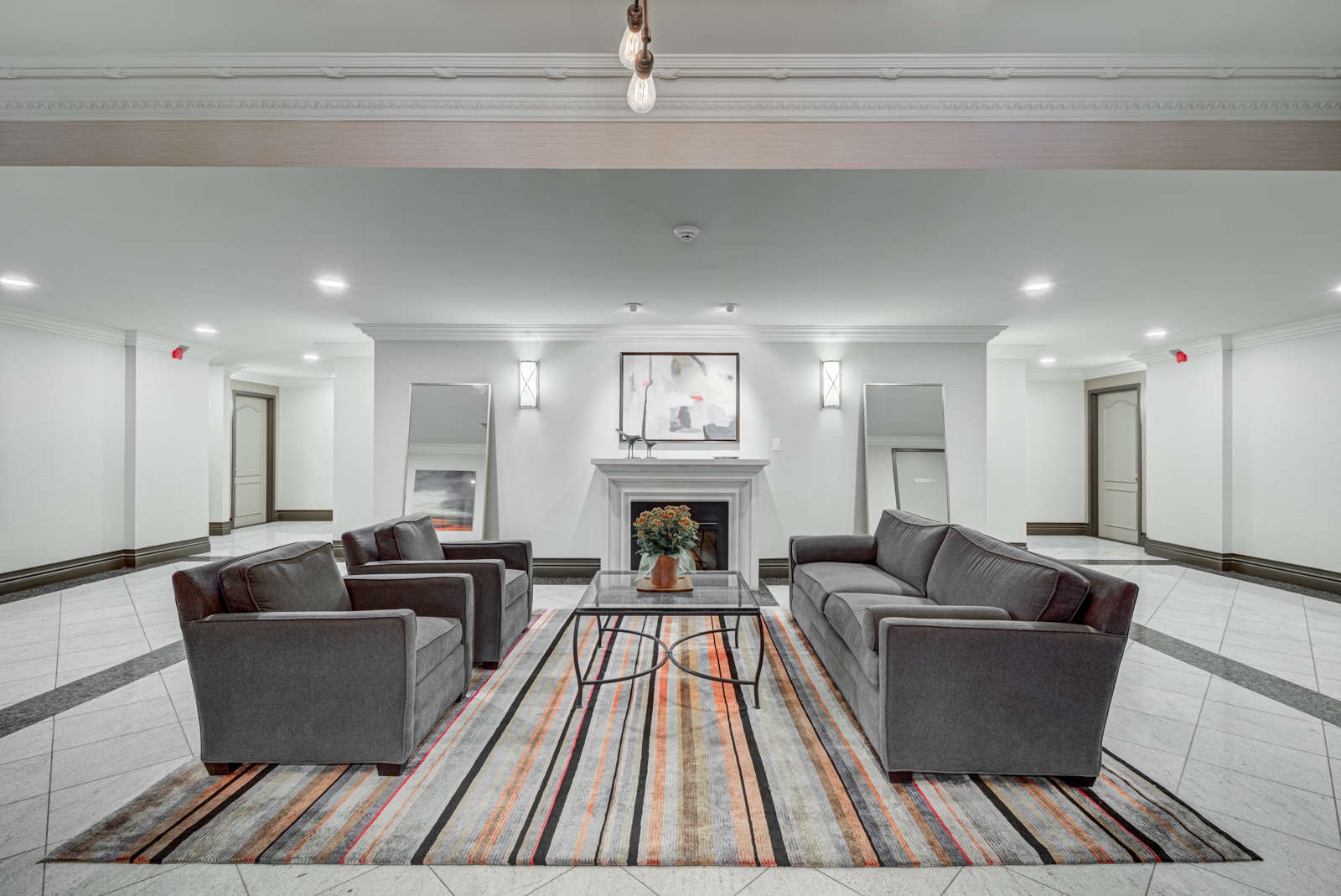 Visitor lounge with 3d sofas and furniture at McMurrich Residences.