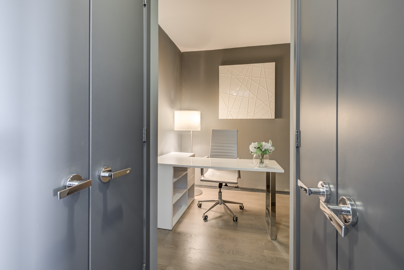 Den and office combo with view of closet door handle.