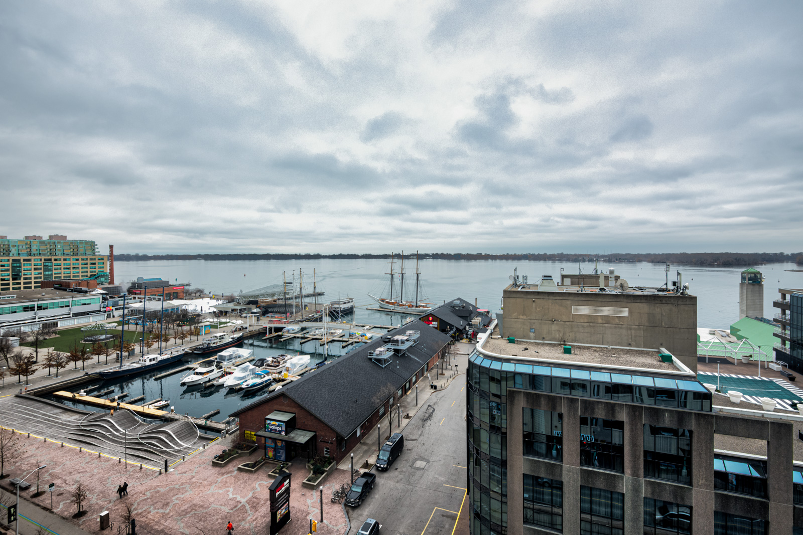 View of Toronto Waterfront, pier with boats, Lake Ontario and streets below Harbourfront II.
