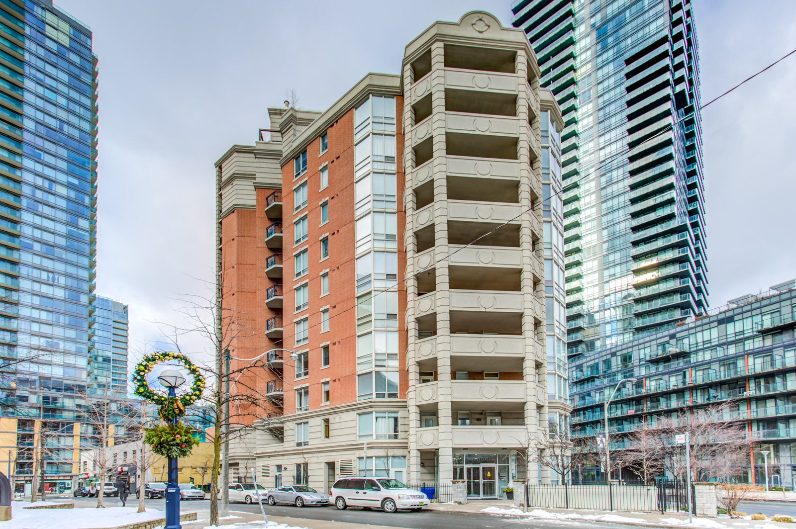 View of 20 Collier St, a 13-storey boutique condo of redbrick and gray stone.