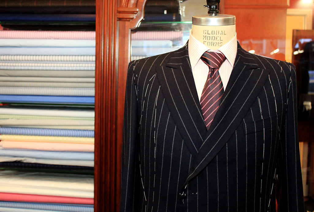 Headless mannequin wearing custom-tailored pin-stripe suit in shop of the Fashion District.