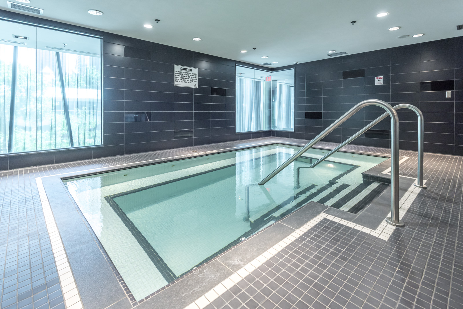 Indoor swimming pool with light green water at The Couture condos.