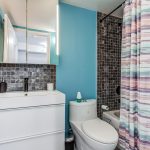 16 bathroom blue walls black tiles colourful curtain black faucet