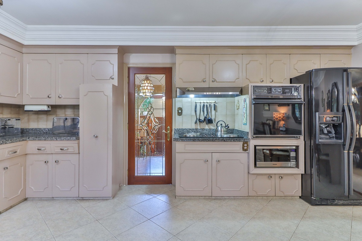 Kitchen with lots of chic beige and brown cabinets