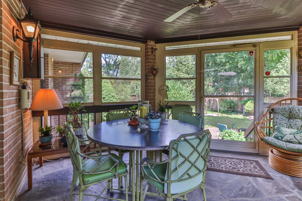 Enclosed patio with small table, few chairs, furniture and view of 6 Parmbelle Cres backyard.