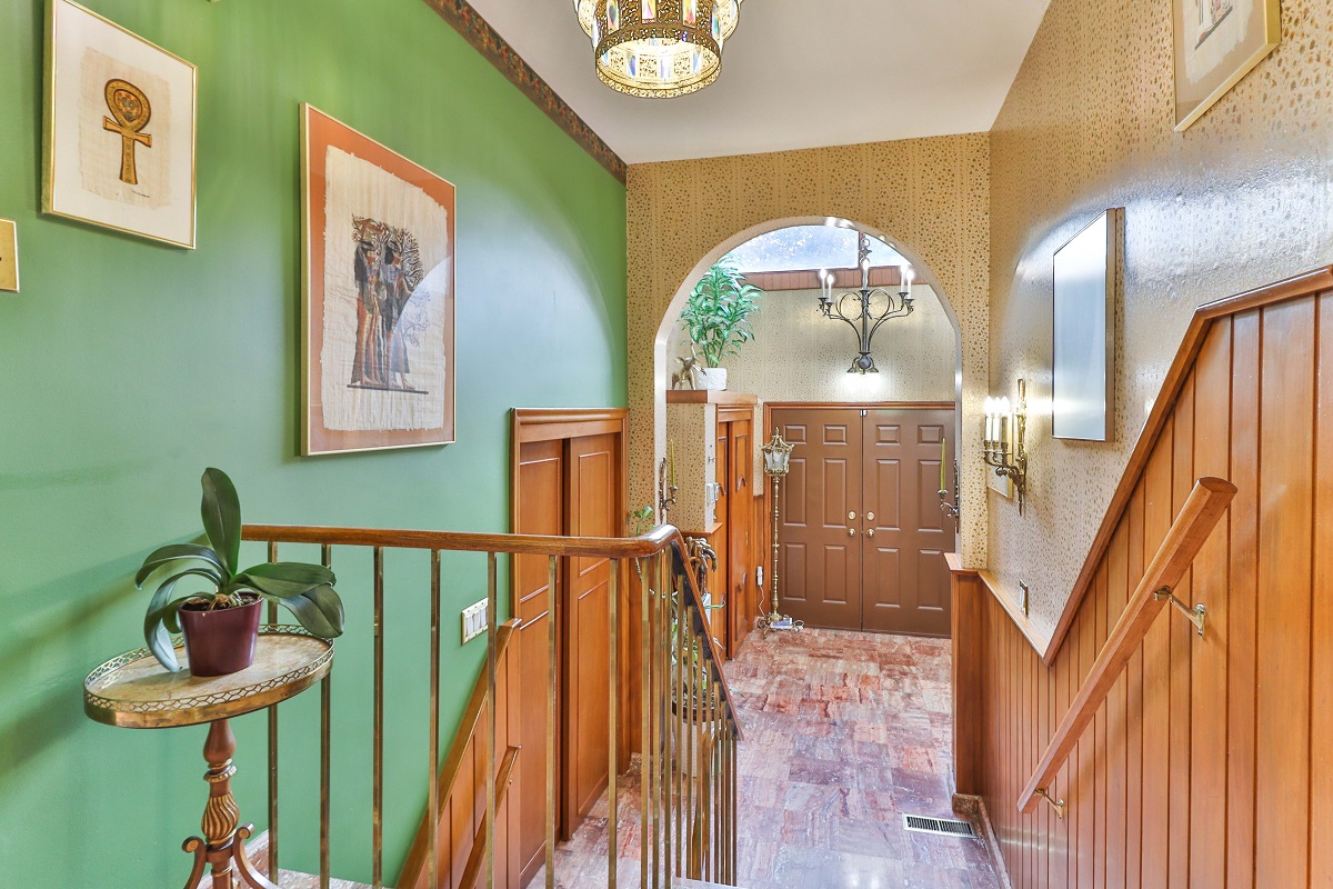 View of 6 Parmbelle Cres entrance, with double doors, 2 chandeliers and green walls.