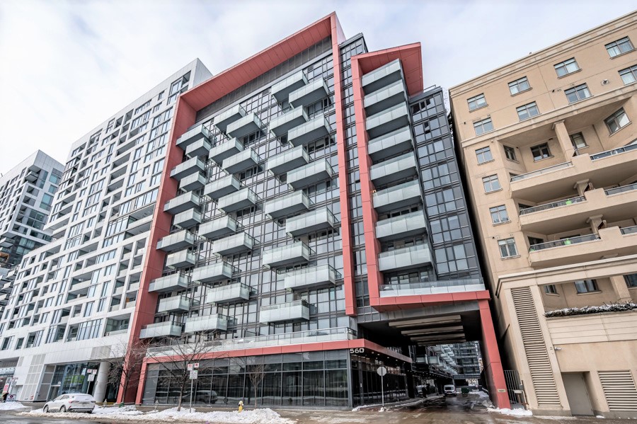Exterior of Reve Condos with glass balconies and rec accents.