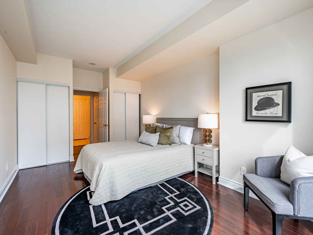 condo master bedroom with large bed and his and her closets Large master bedroom with His and Her closets.