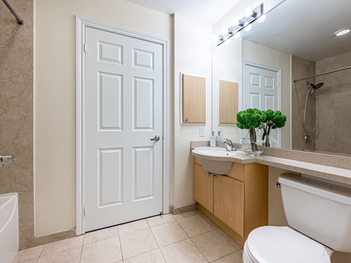 4 piece condo bathroom with large vanity stone floors and under sink storage 4-piece bathroom with stone floors, huge vanity and under-sink storage cabinets.