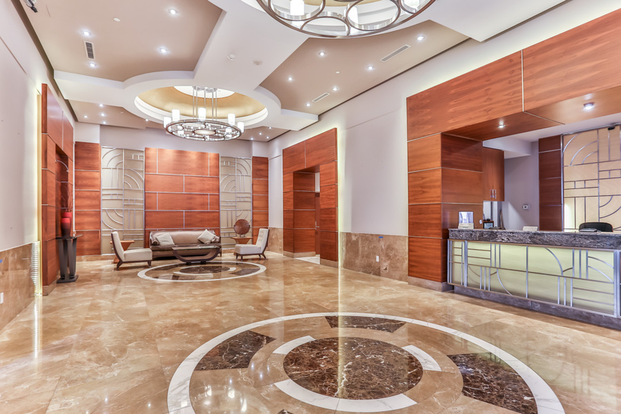 2 sophisticated condo lobby with chandeliers and wall designs Sophisticated condo lobby with chandeliers, sleek tiles and wall designs.