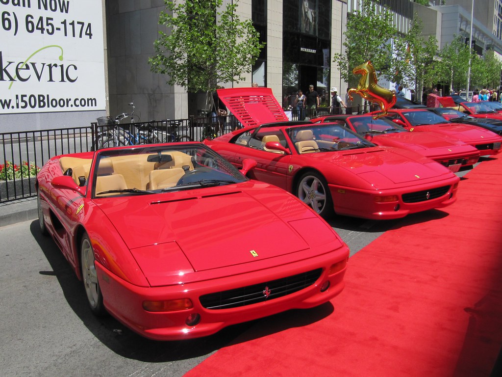 Line of red Ferraris at Yorkville Exotic Car Show. 