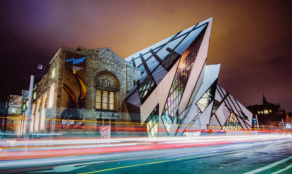 royal ontario museum exterior night light trails Royal Ontario Museum at night with traffic light trails.