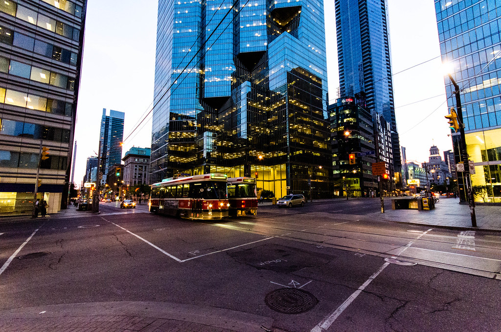 toronto financial district street cars buildings Two red and white streetcars in Toronto's Financial District.