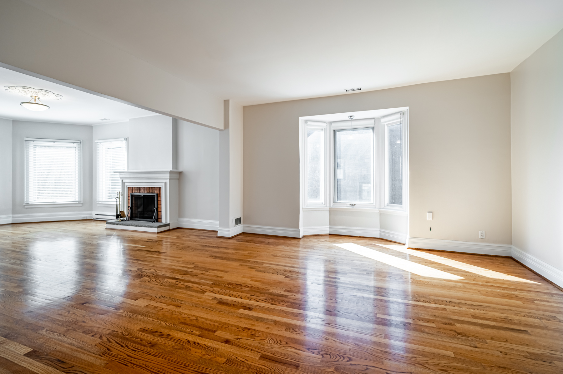 98 Bedford Rd – large living and dining room with hardwood floors and fireplace.