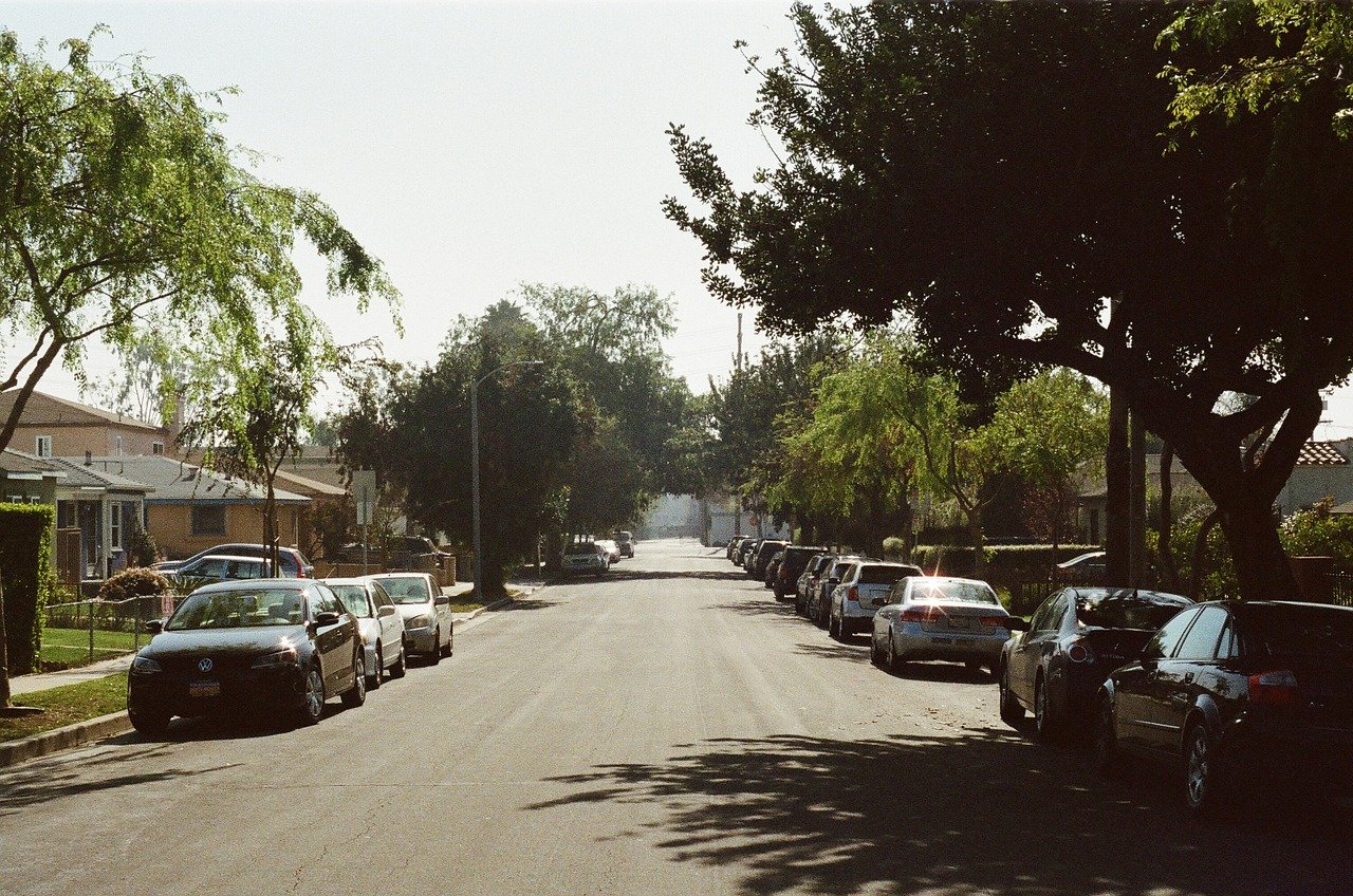 Cars parked along suburban street.