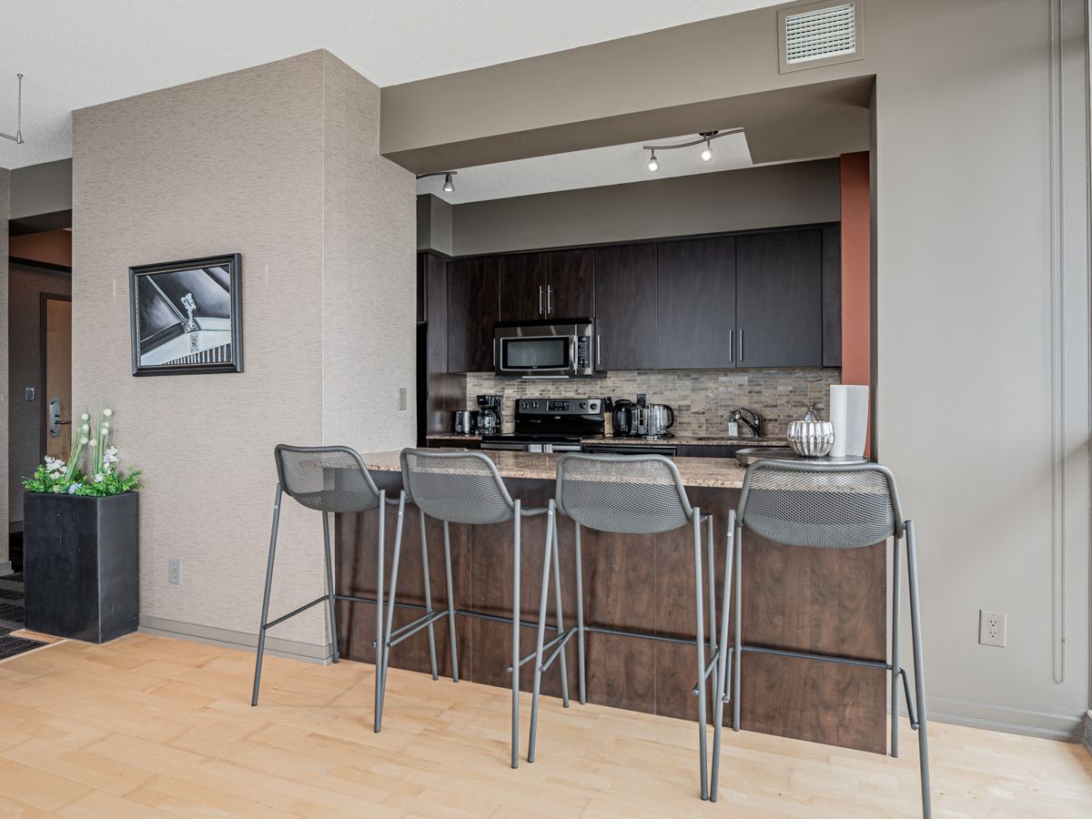 Condo with breakfast bar and stools.