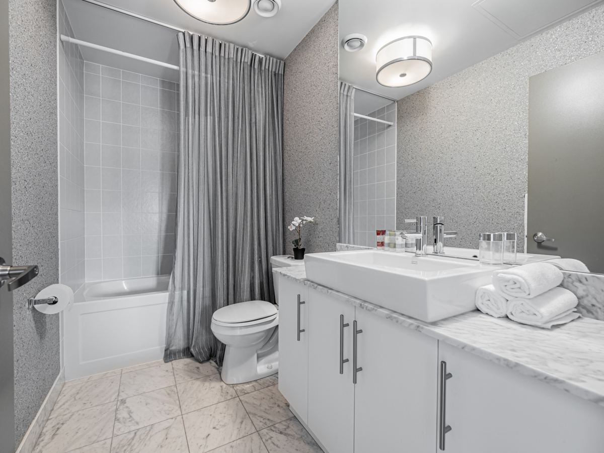 55 Bremner Blvd Unit 4709 – second bathroom with gray colour scheme.