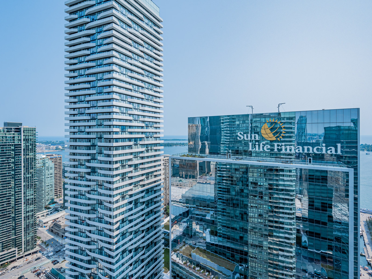 View of shiny, glass-covered Sun Life Financial building from balcony.