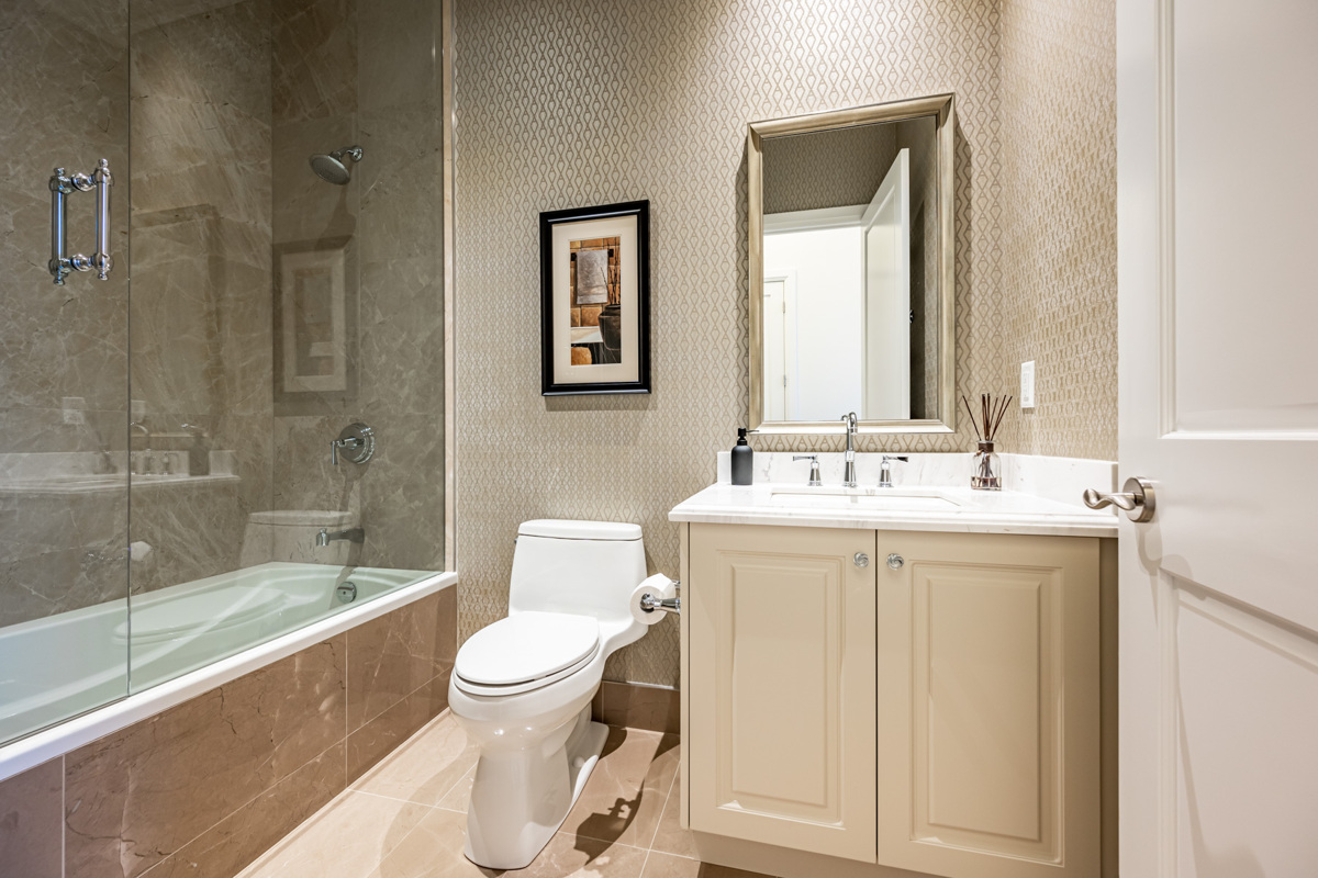 Bathroom with marble tiles and fancy wallpaper – 388 Yonge St PH 7907.