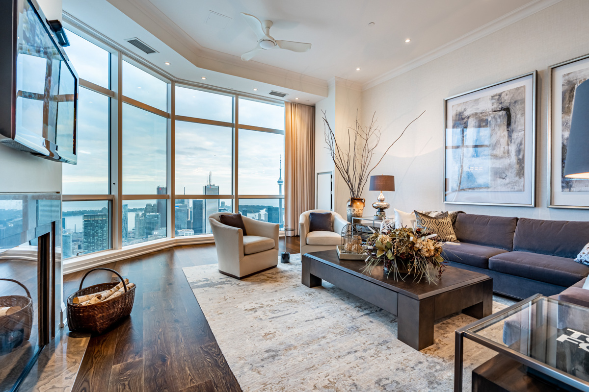 Penthouse with tall ceilings, crown moulding and potlights.