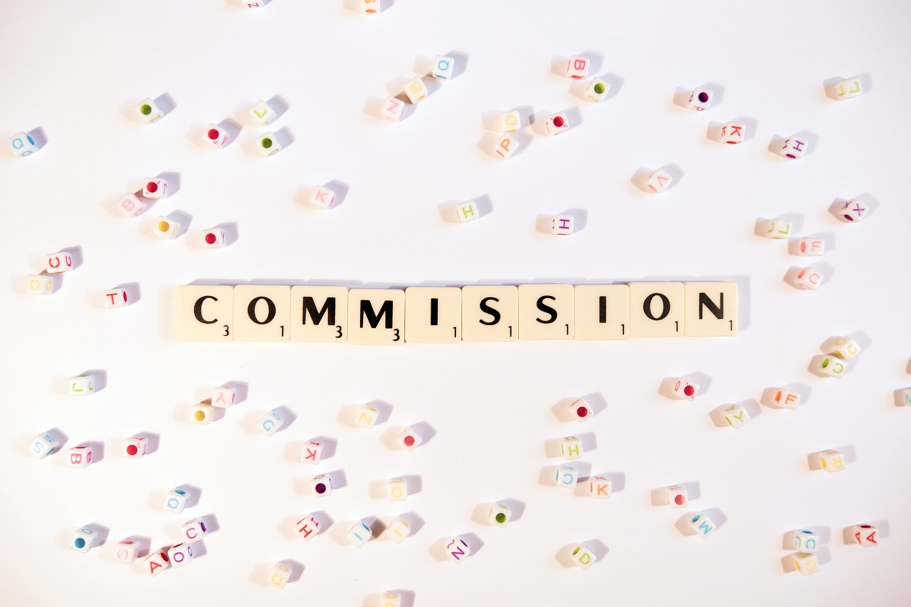 Scrabble tiles spelling "Commission" for FAQs page.