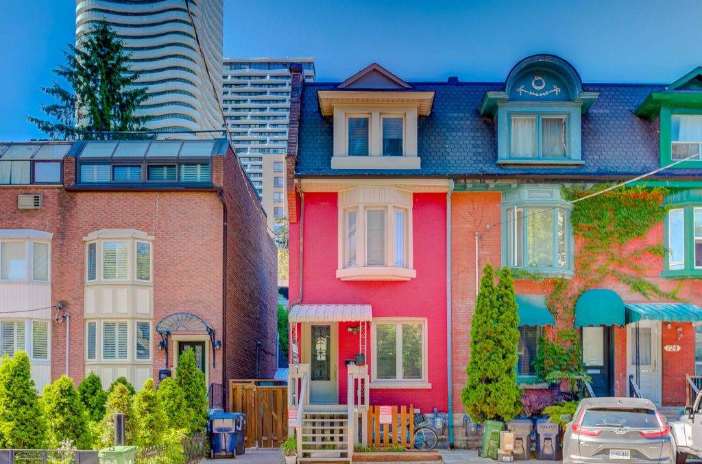 Row of colourful Victorian townhouses in Toronto real estate.