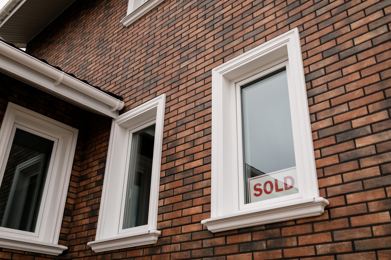 Sold sign in house window.