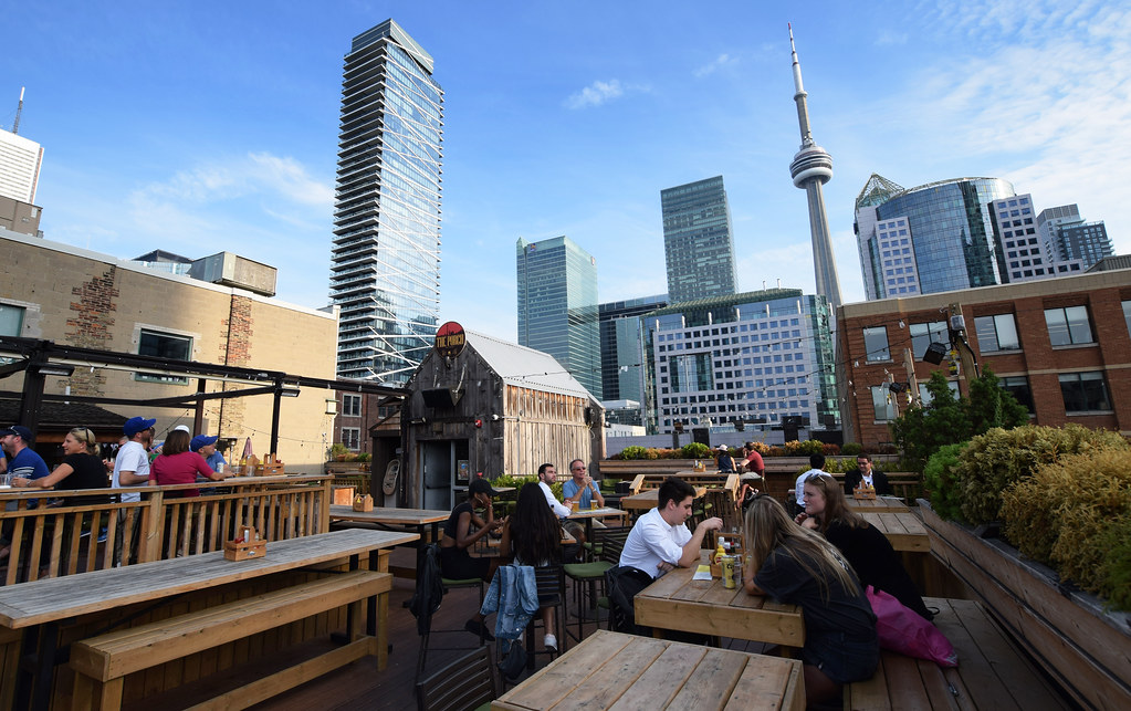 Rooftop patio in Toronto with CN Tower in background.