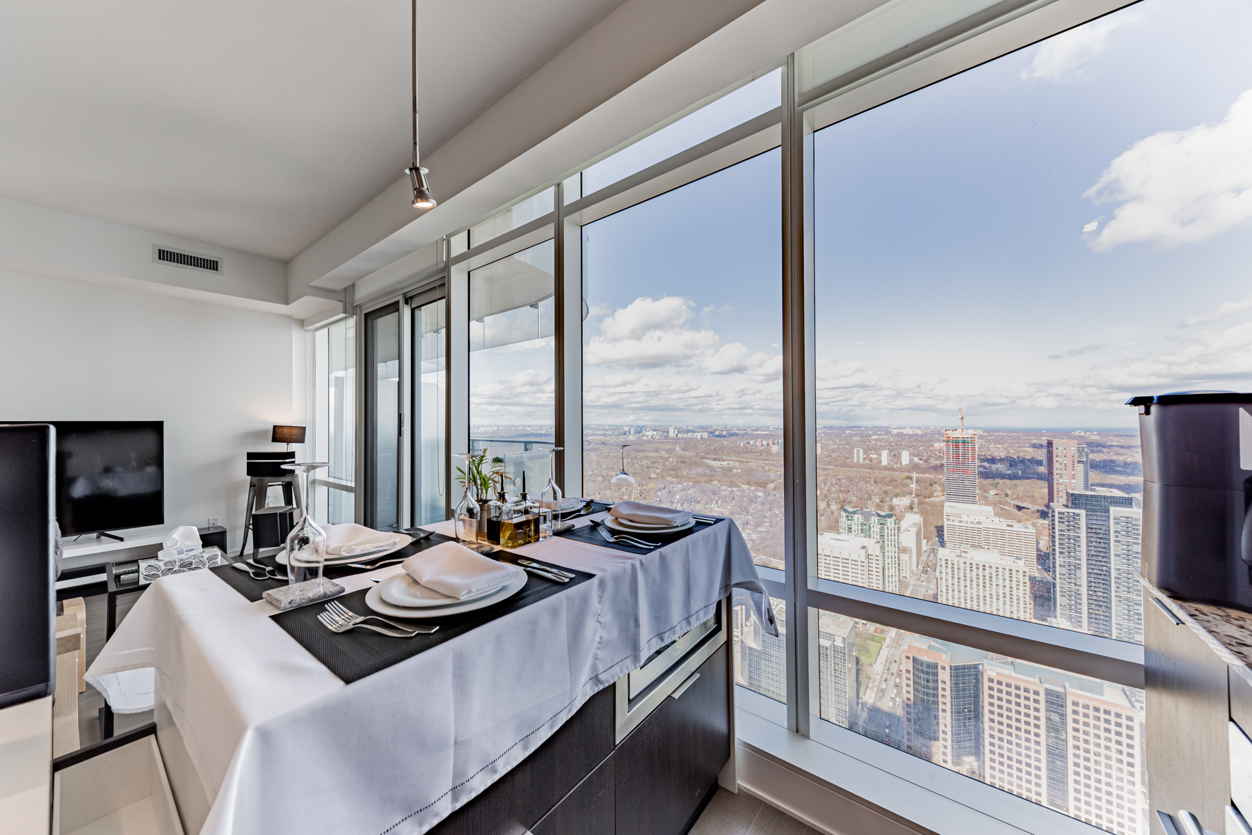 1 Bloor St E Unit 5803 dining table with great view of city.