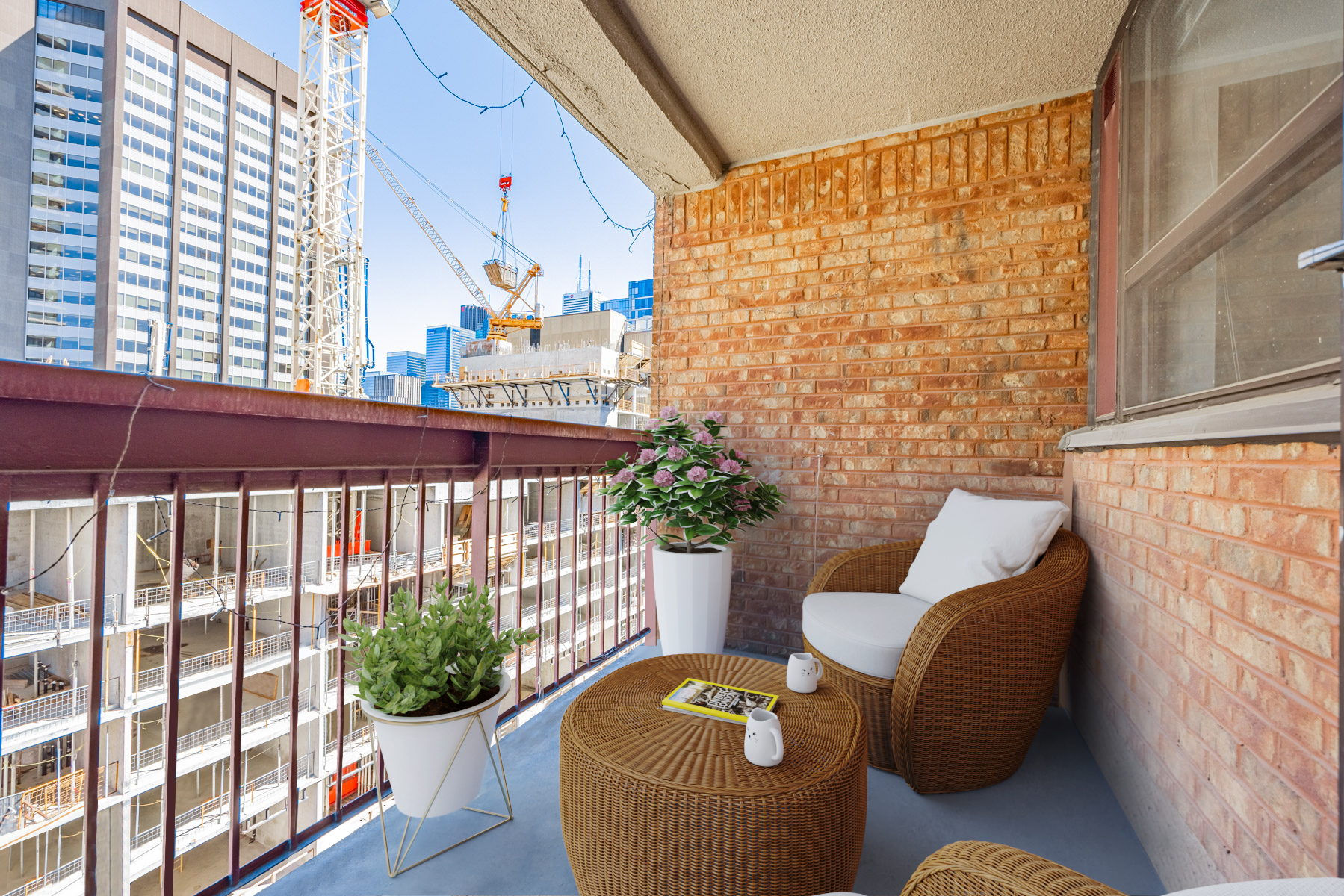 120 St Patrick Street Unit 807 balcony with red-brick wall and patio furniture.
