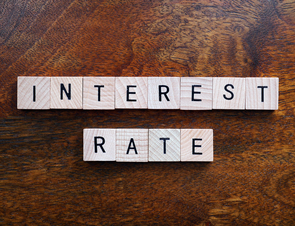 scrabble tiles spelling word "Interest Rate" to show March 2022 rate hike.