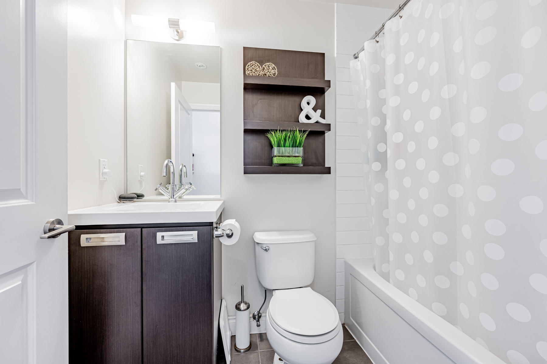 15. 90 Stadium Rd Unit 824 bathroom ceramic floors wall shelves soaker tub 90 Stadium Rd Unit 824 bathroom with ceramic floors, wall-mounted shelves and soaker tub.