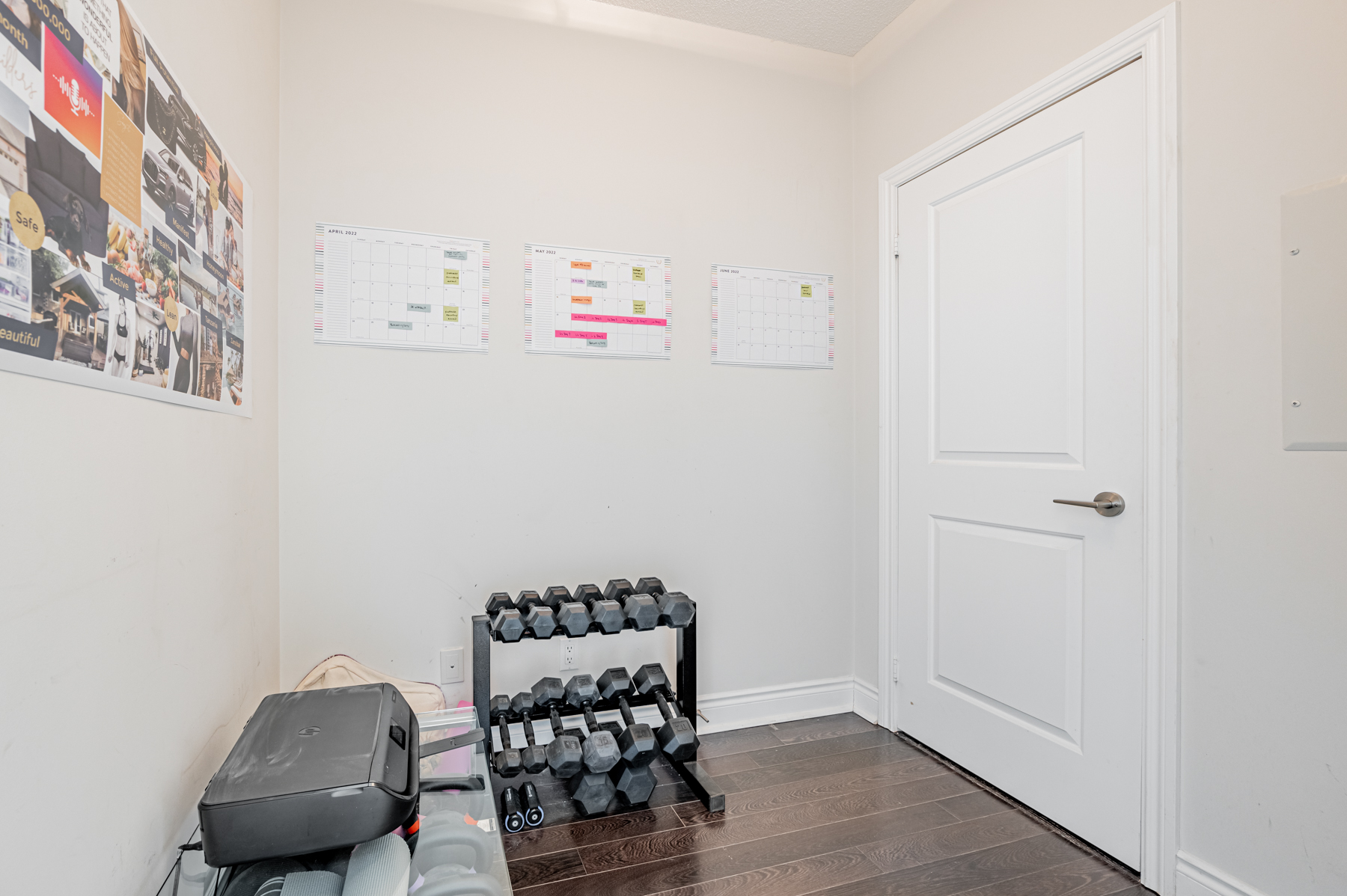 16. 90 Stadium Rd Unit 824 den used as storage room 90 Stadium Rd Unit 824 den with dumbbells, printer and other items.