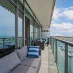 Long condo balcony with 2 sofas and bicycle – 90 Stadium Rd Unit 824.