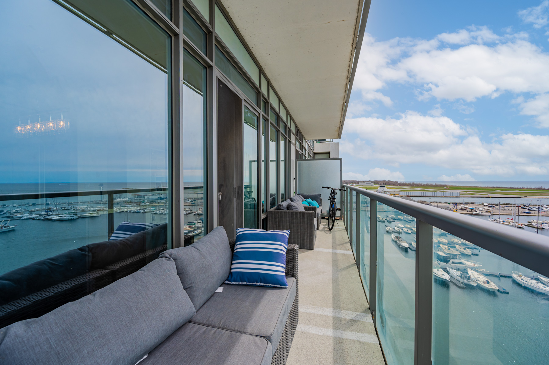 18. 90 Stadium Rd Unit 824 long balcony with 2 sofas bicycle Long condo balcony with 2 sofas and bicycle – 90 Stadium Rd Unit 824.