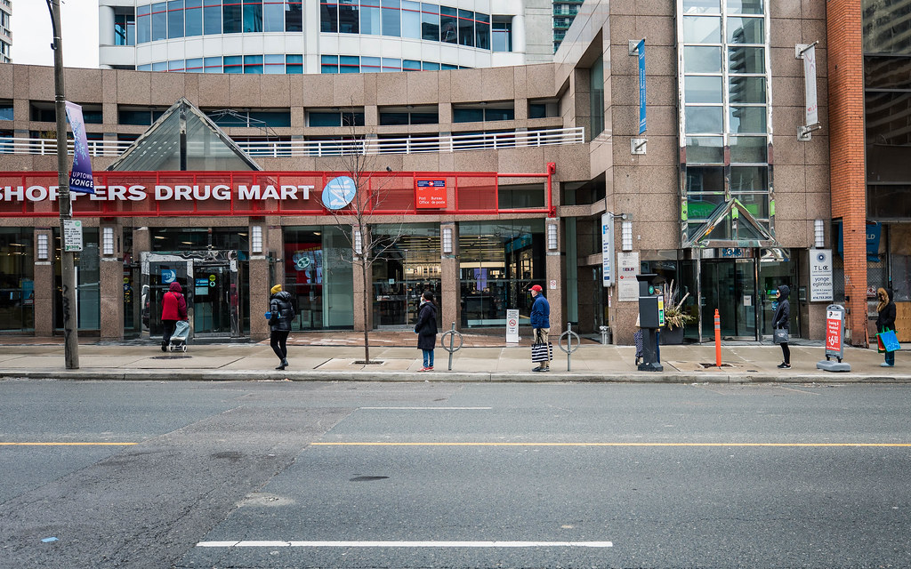 People lining up outside Shoppers Drug Mart in Toronto.