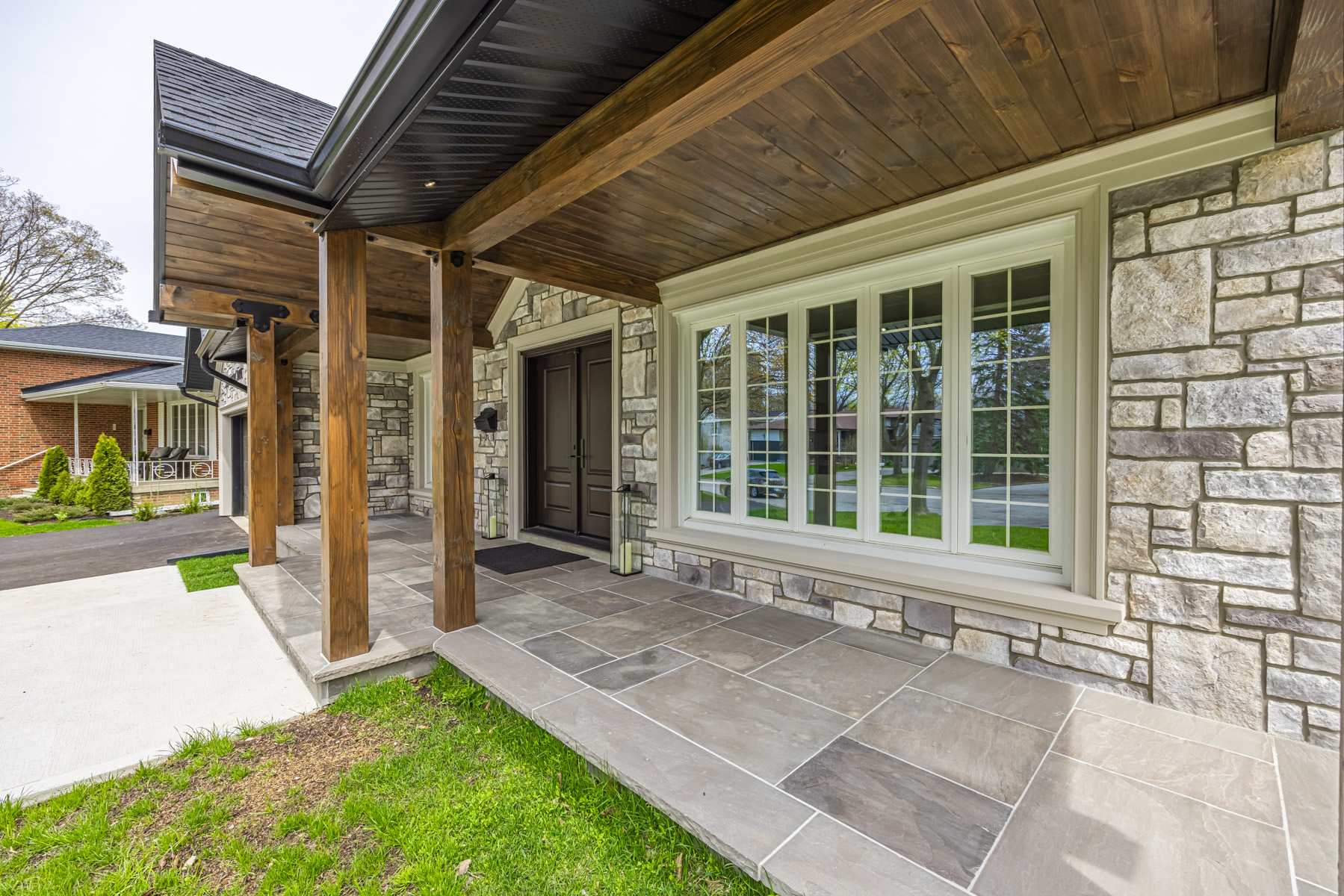 House with wood panels in ceiling, Douglas fir posts and stone patio – 3 Logwood Court.