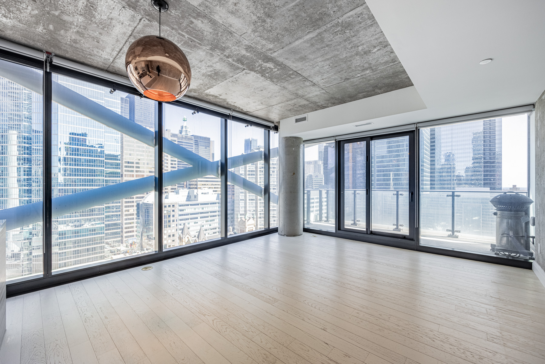 Brightly lit condo with wall-to-wall windows.
