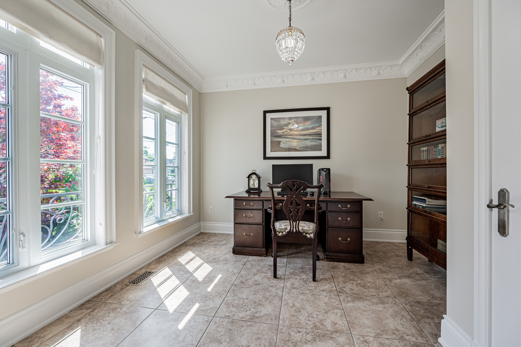 12 Highland Hill home office with desk, chandelier, porcelain floors and large windows.