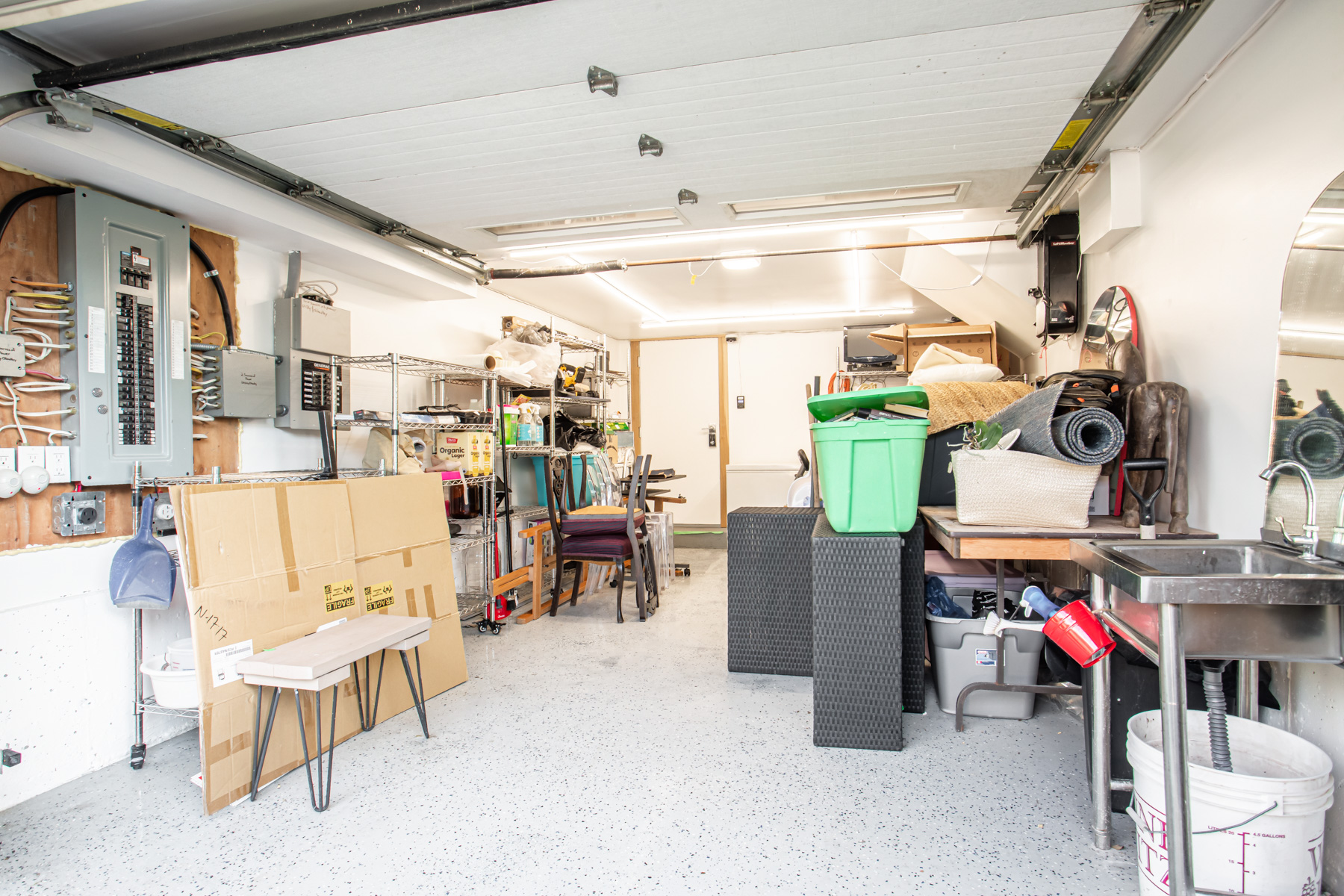 Garage with epoxy floors full of various items.