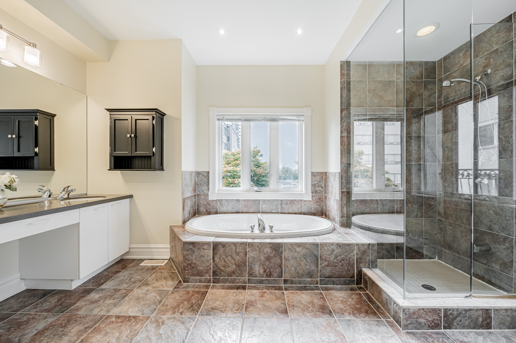 Large ensuite bath with dark ceramic tiles – 23 Annex Lane.