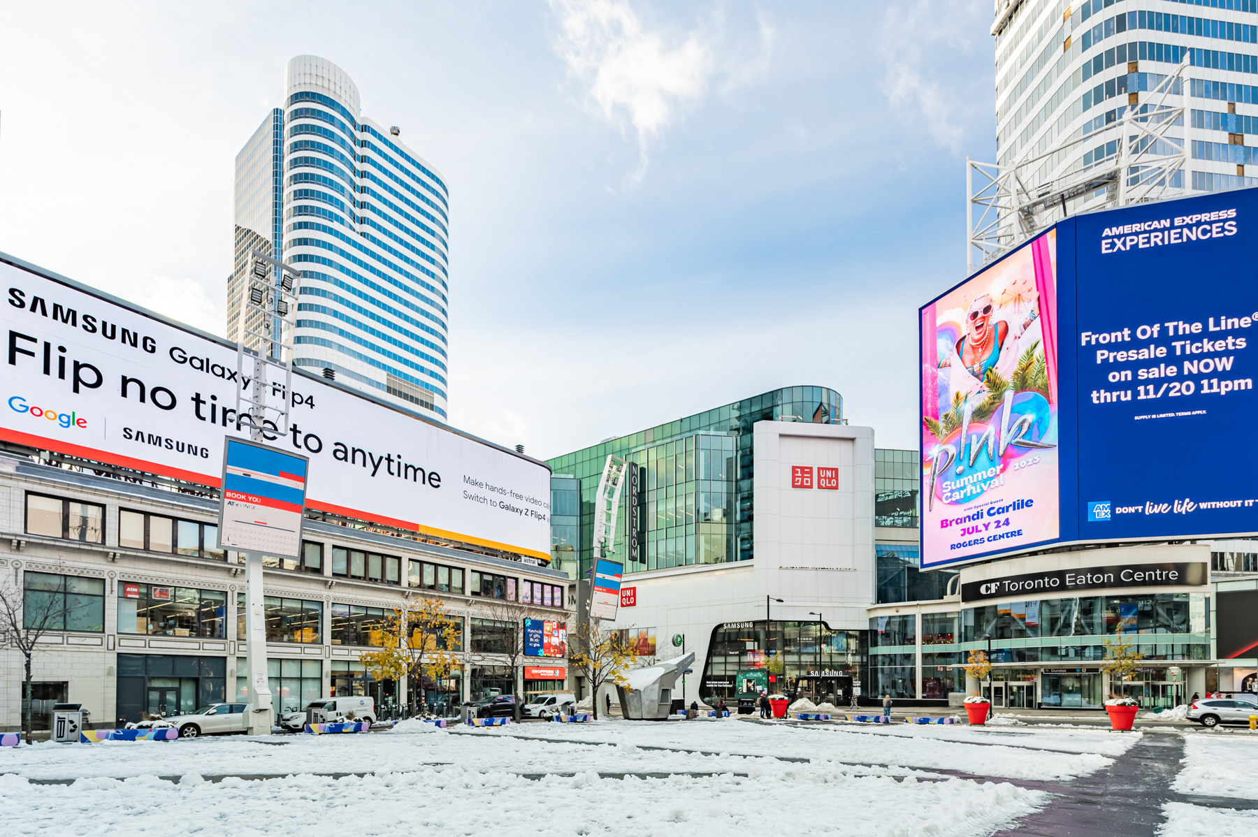 Electric billboards, snow and photo of Eaton Centre from distance.